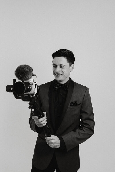 Corey Combs holding a filmmaking camera rig, photographed by Erin Marie Photos